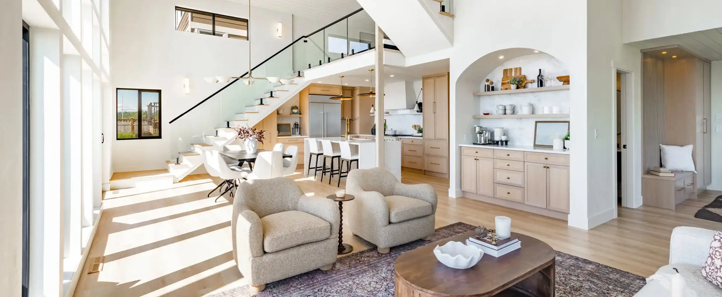 Modern open-plan living room with staircase.
