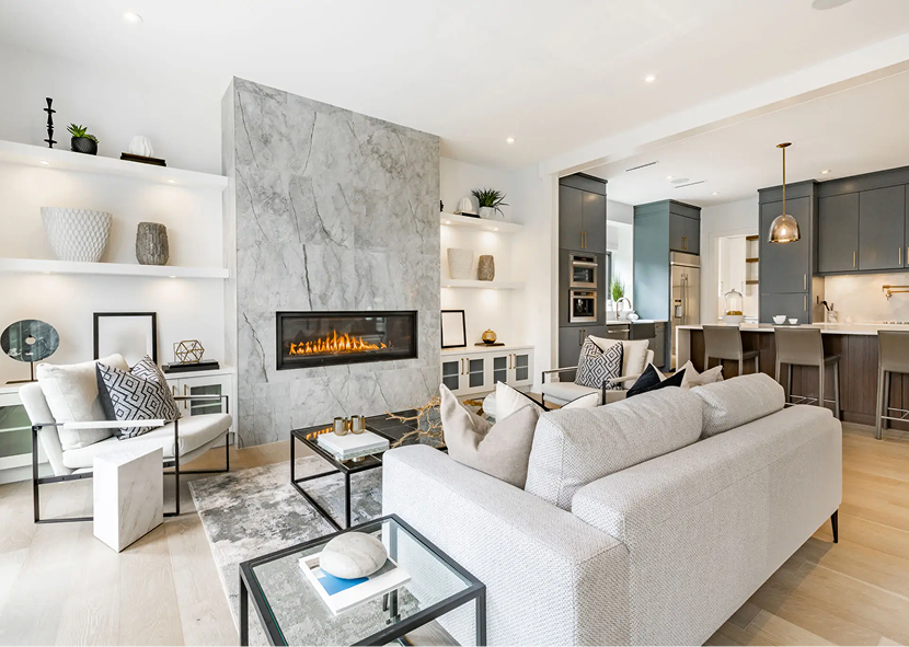 Modern living room with fireplace and kitchen.