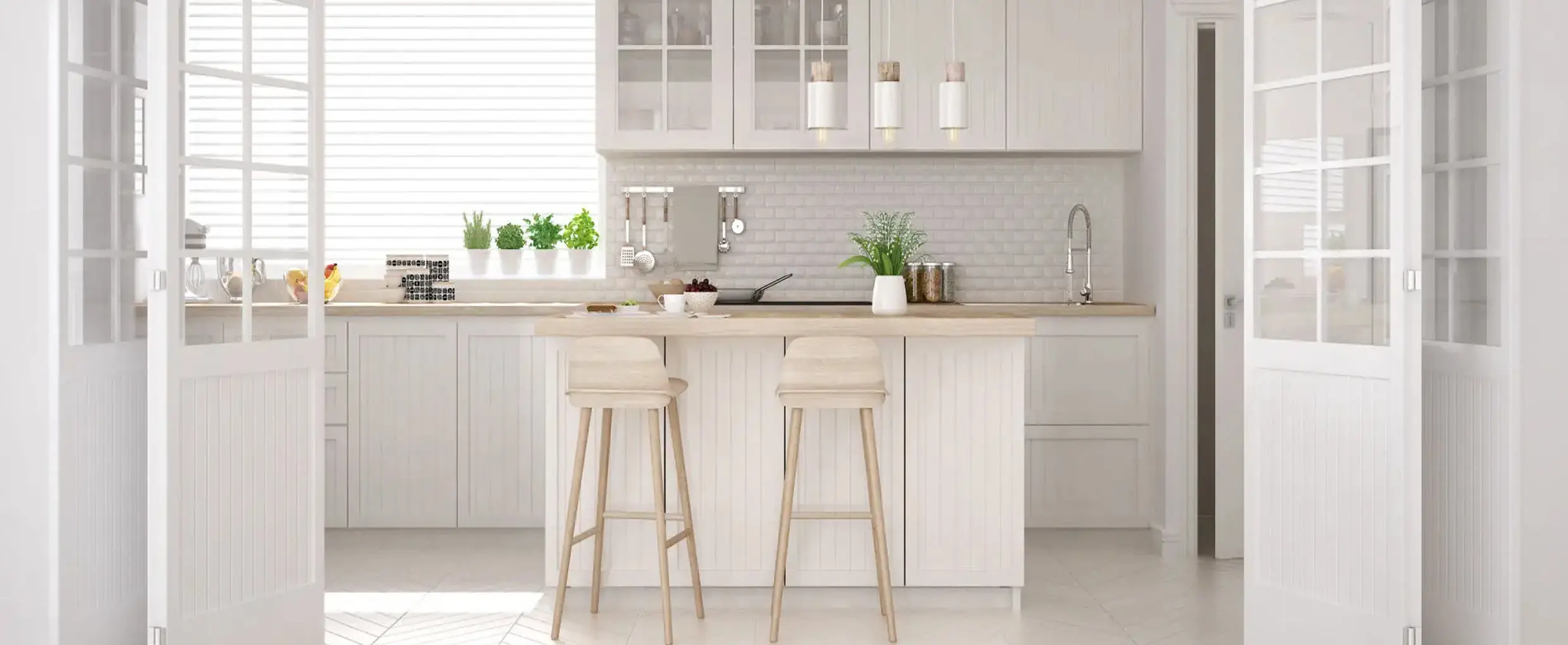 Minimalist white kitchen with island and stools.